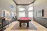 Enjoy a friendly game of pool in the community's dedicated billiards room, featuring a full-size pool table, stylish finishes, and an inviting recreat
