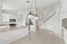 An inviting kitchen and breakfast area featuring white cabinetry, generous counter space, and an open design that connects seamlessly to the surroundi