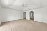 This generously sized primary suite offers an elegant tray ceiling, plush carpeting, and an expansive layout with plenty of room to create your own pe