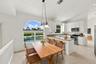 Enjoy picturesque views of the surrounding greenery from the charming breakfast nook, complete with an oversized arched window, vaulted ceilings, and 