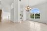An elegant chandelier, soaring ceilings, and an open connection to the adjacent living areas create a wonderful setting for entertaining.