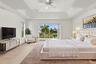 Wake up to beautiful waterfront views! Sliding glass doors open directly onto a private second-story balcony overlooking the tranquil lake and tropica