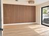 Vertical wood slat accent wall, light-toned wood-finish flooring, sliding glass door, and integrated circular drum lighting fixture