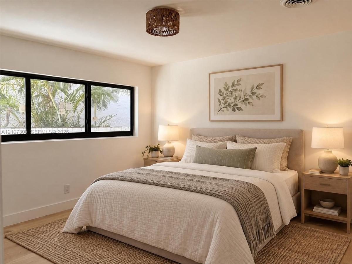 Neutral interior featuring wood-finish flooring, a black-framed window, and a woven flush-mount ceiling fixture