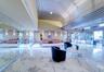 Polished stone flooring, mirrored wall panels, linear metal ceiling detailing, and recessed LED lighting