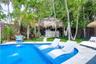 2 lounge chairs and center table inside of the pool to enjoy a cocktail under the sun