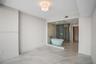 Freestanding soaking tub encased in a floor-to-ceiling glass partition, large-format tile flooring, and integrated walk-in closet shelving
