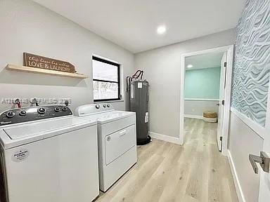Laundry room featuring wood-finish flooring, recessed lighting, and textured accent wall covering