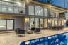 Outdoor waterfront Point Lot with pool area with outdoor dining, lounge chairs, BBQ & siting area.