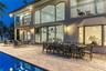 Outdoor waterfront Point Lot with pool area with outdoor dining, lounge chairs, BBQ & siting area.