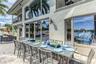 Outdoor waterfront Point Lot with pool area with outdoor dining, lounge chairs, BBQ & siting area.