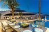 Outdoor waterfront Point Lot with pool area with outdoor dining, lounge chairs, BBQ & siting area.