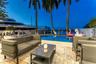 Outdoor waterfront Point Lot with pool area with outdoor dining, lounge chairs, BBQ & siting area.