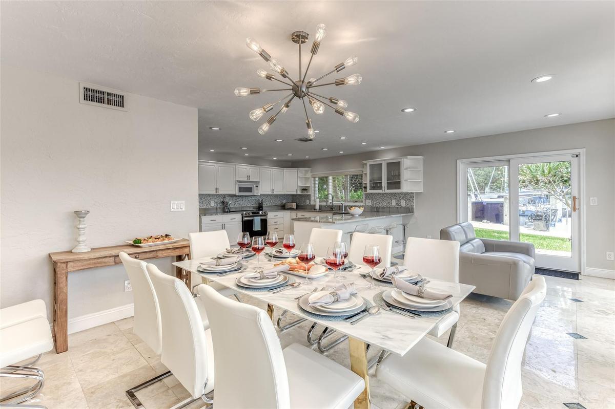 Dining Room Seating for 8 of Kitchen overlooking pool & waterway.