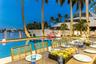 Outdoor waterfront Point Lot with pool area with outdoor dining, lounge chairs, BBQ & siting area.