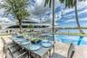 Outdoor waterfront Point Lot with pool area with outdoor dining, lounge chairs, BBQ & siting area.
