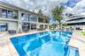 Outdoor waterfront Point Lot with pool area with outdoor dining, lounge chairs, BBQ & siting area.