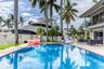 Outdoor waterfront Point Lot with pool area with outdoor dining, lounge chairs, BBQ & siting area.