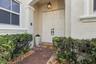 Covered entryway with a brick-paver walkway, double-door entrance, and overhead lantern-style lighting
