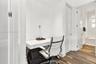 Built-in white desk with drawer storage, recessed lighting, and wood-finish flooring