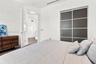Sliding closet doors with dark wood-finish panels, recessed ceiling lighting, and crisp white walls