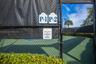 Dedicated pickleball courts featuring perimeter chain-link fencing, privacy windscreens, and surface court markings