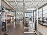 Fitness facility featuring a coffered ceiling, floor-to-ceiling windows, and recessed lighting