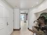 Entry foyer featuring natural stone tile flooring, recessed lighting, and a custom built-in wall niche with architectural molding