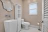 1/2 BATHROOM BETWEEN THE GARAGE AND LAUNDRY ROOM