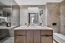 Custom light-toned wood cabinetry with integrated shelving and task lighting, built-in desk, wall-mounted light fixtures, ceiling fan, and expansive w