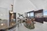 Vertical wood-slat wall paneling, flush-mount ceiling lighting, and large-format tile flooring