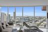 Floor-to-ceiling windows providing extensive city and water exposure, complemented by polished flooring