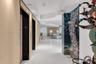 Polished tile flooring, recessed ceiling lighting, and wood-paneled walls featuring a private elevator entry