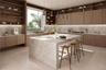 Kitchen featuring wood cabinetry, natural stone countertops with a waterfall edge island, under-cabinet lighting, and built-in shelving