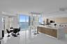 Open-concept kitchen featuring an expansive island with a waterfall-edge countertop, dual built-in ovens, light-finish cabinetry, polished tile floori