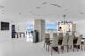 Open-concept living space featuring high-gloss tile flooring, floor-to-ceiling windows with ocean scenery, a central concrete pillar, recessed lightin
