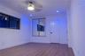 Interior space featuring wood-finish flooring, recessed lighting, a ceiling fan with integrated light, a paneled interior door, and large windows with