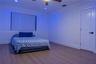 Wood-finish flooring, recessed lighting, ceiling fan with integrated light, pleated window shade, and solid-core interior door with matte black hardwa
