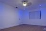 Interior room featuring wood-finish flooring, recessed lighting, a ceiling fan with integrated light fixture, and a single-panel interior door with ma