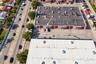 Industrial property featuring direct frontage on a high-traffic thoroughfare, multiple roll-up bay doors, and an expansive asphalt parking lot