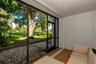 Screened-in patio featuring textured walls, tile flooring, and metal-framed screen enclosures