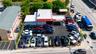 Commercial property featuring a flat-roof structure with a covered drive-through canopy and paved asphalt lot