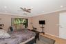 Primary Bedroom featuring wood-finish flooring, recessed lighting, a ceiling fan with integrated light kit, and a sliding glass door