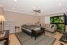 Primary bedroom. Light-toned wood-finish flooring, recessed ceiling lighting, central ceiling fan with integrated light fixture, crown molding, and sl
