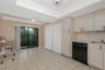 Kitchen featuring gloss-finish cabinetry, built-in dishwasher, integrated sink, tile flooring, and sliding glass doors with tray ceiling detail. large