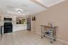 Kitchen featuring white flat-panel cabinetry, stainless steel appliances, tiled flooring, and a tray ceiling with recessed lighting