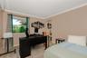 Room featuring neutral-toned walls, crown molding, a large single-pane window, and mirrored sliding closet doors