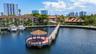 Waterfront gazebo with a clay tile roof, concrete pier, and dedicated boat slips
