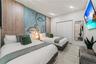Custom accent wall featuring wood-finish panels and central artistic mural, recessed ceiling lighting, and large-format tile flooring