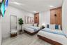 Bedroom featuring large-format tile flooring, a geometric tile accent wall, integrated vertical wood-slat paneling, and recessed lighting